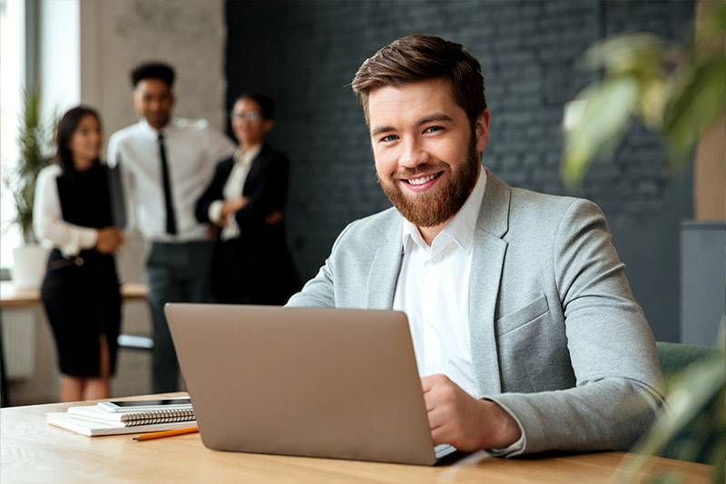 HR consultant supporting a business client at a laptop