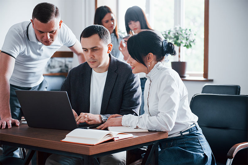 Colleagues congratulating an employee in the workplace